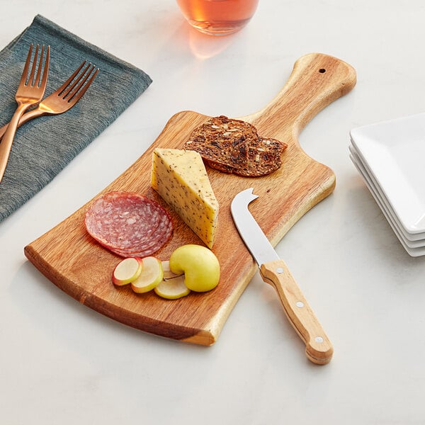 An Acopa acacia wood serving board with a piece of cheese and pepperoni on it.