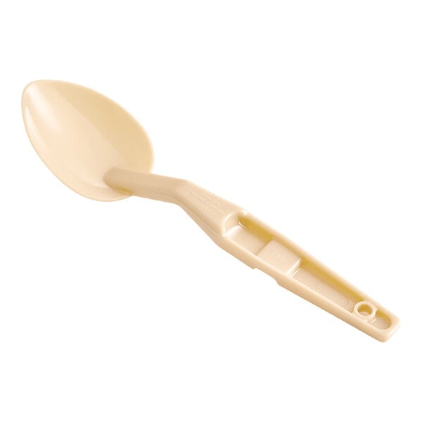 A beige plastic Cambro salad bar spoon with a long handle.