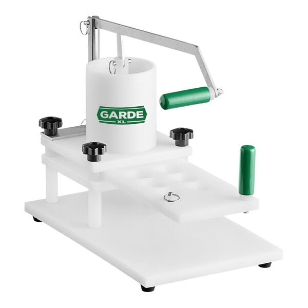 A white Garde slider press with a green handle.