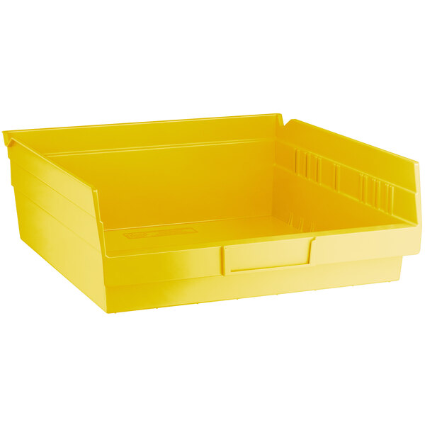 A close up of a yellow Regency plastic shelf bin.