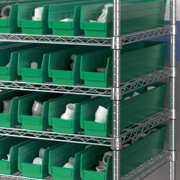 Metal shelving with Regency green bins holding white containers.