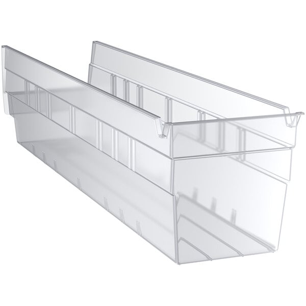 A clear plastic Regency shelf bin with two compartments.