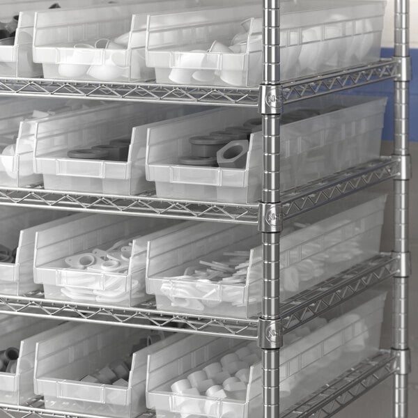 A metal shelf with Regency clear plastic bins inside.