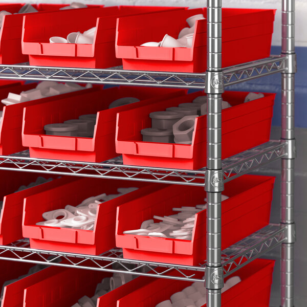 A metal rack with red Regency shelf bins containing white objects.