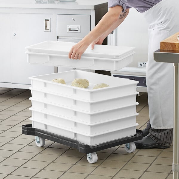 pizza dough boxes stacked on a dolly