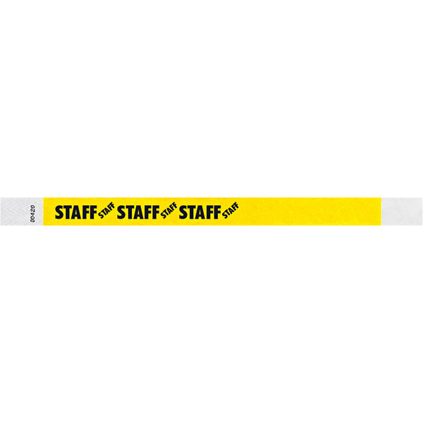 A yellow Tyvek wristband with black text that reads "STAFF"