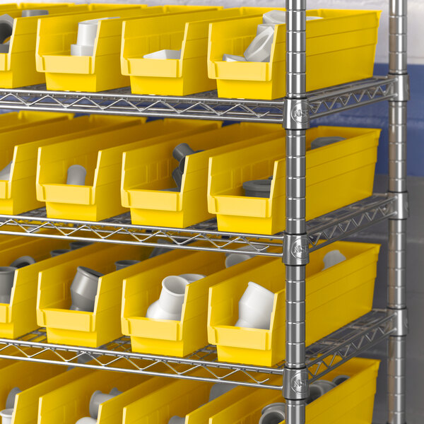 Regency yellow shelf bins on metal shelving with white objects inside.