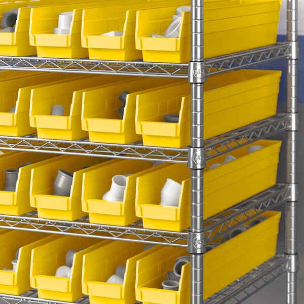 A metal shelving rack with Regency yellow bins on a metal shelf.