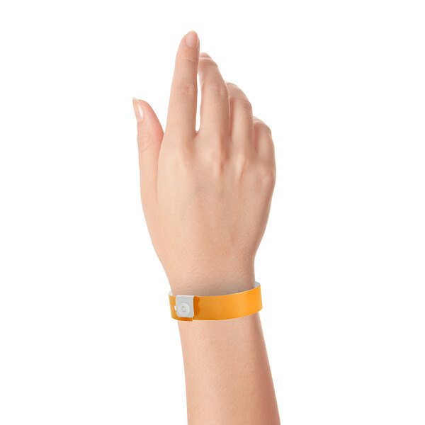 A person holding a Carnival King neon orange vinyl wristband.