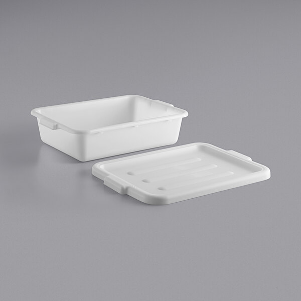 A white plastic container with a lid on a gray surface.