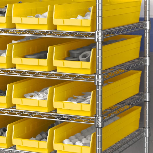 A metal shelving unit with yellow Regency shelf bins filled with white and grey items.