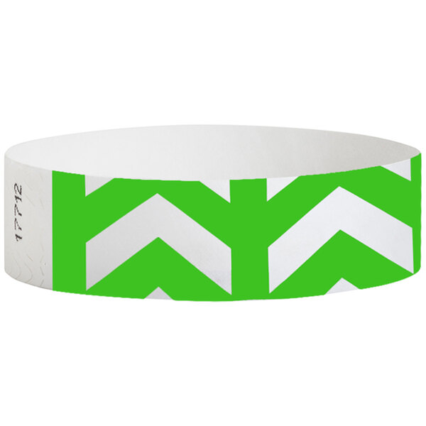 A white wristband with green chevron arrows.