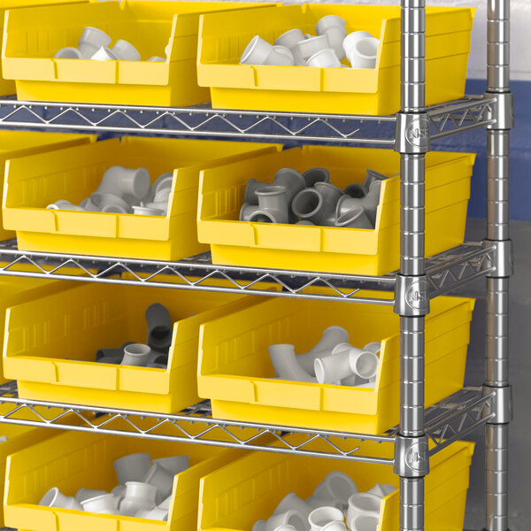 A shelf with yellow Regency shelf bins containing white objects.