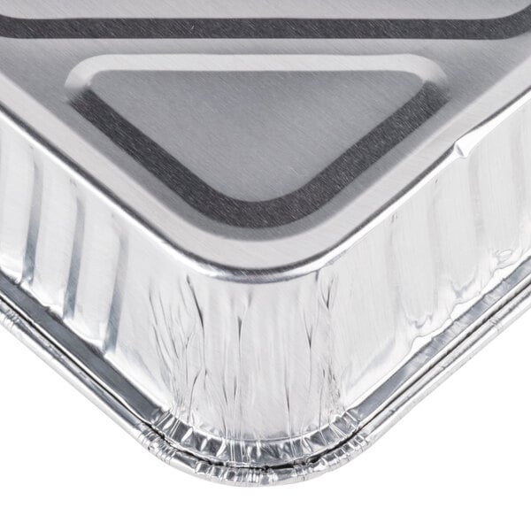 An 8" square foil cake pan with a black lid on it.