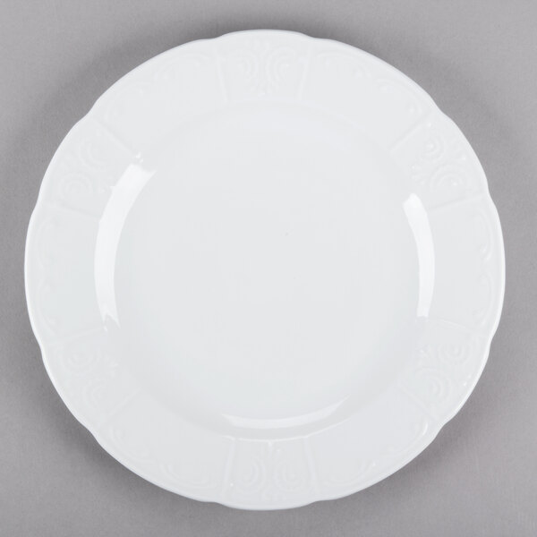 A close-up of a Tuxton Chicago bright white china plate with a decorative design.