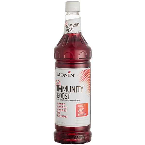 A close up of a Monin Total Immunity Boost beverage enhancer bottle filled with red liquid.