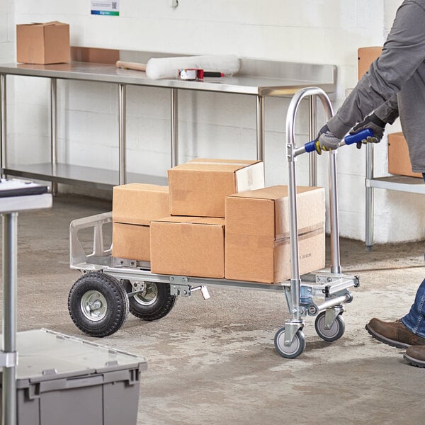 A man using a Lavex 2-in-1 hand truck to move boxes.