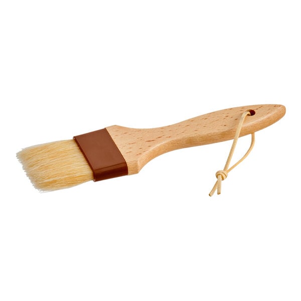 A 2-inch wide boar bristle pastry or basting brush with a wooden handle and a hanging loop.