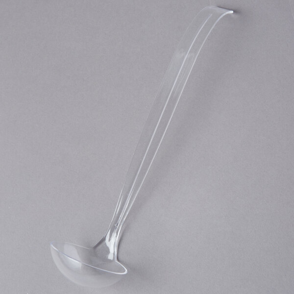 A clear plastic ladle with a handle.