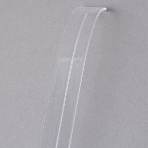 A clear plastic tube with a clear plastic ladle inside.