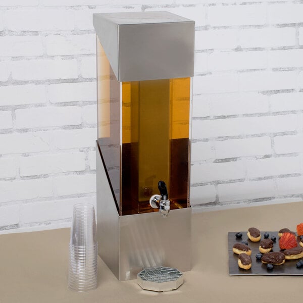 A silver stainless steel Cal-Mil beverage dispenser with an ice chamber.