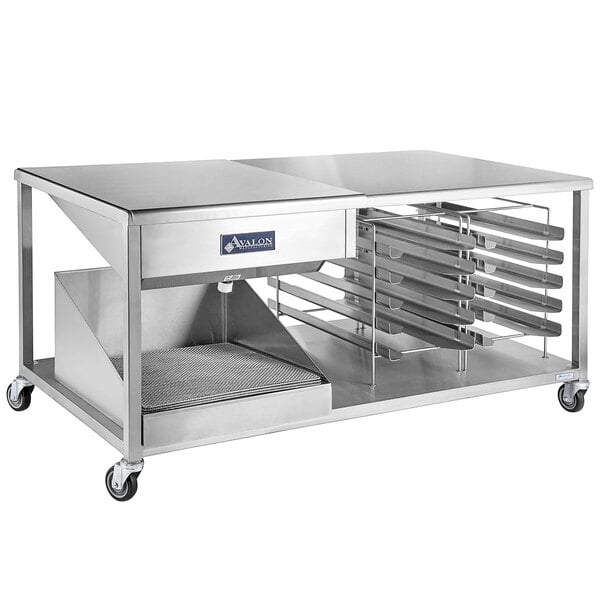 A stainless steel work table with a tray on it.