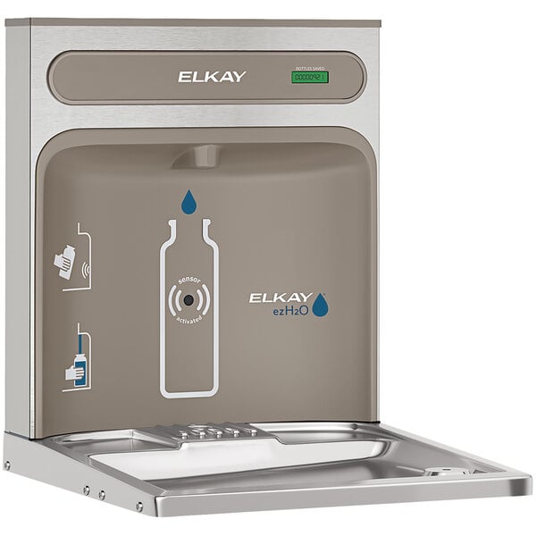 An Elkay ezH20 water bottle filling station on a silver counter.