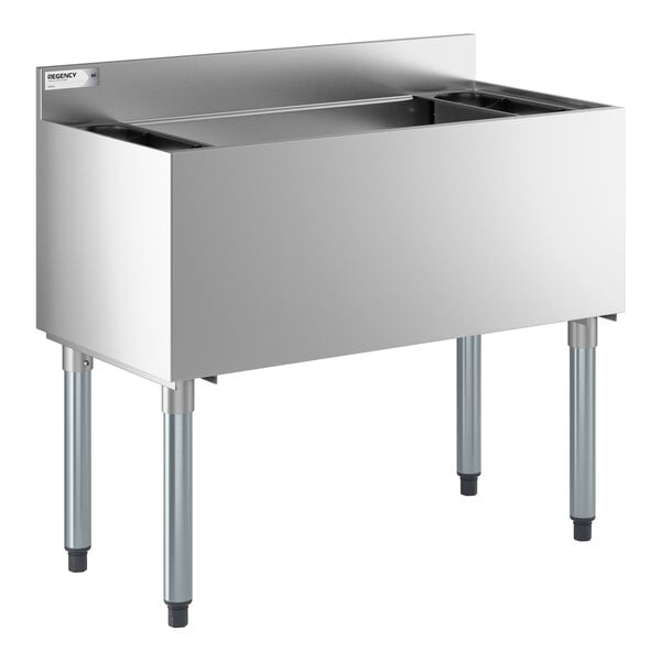 An underbar ice bin with a 7 circuit post-mix cold plate and bottle holders, made of stainless steel.