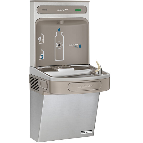 An Elkay stainless steel water bottle filling station attached to a water fountain with a bottle on it.