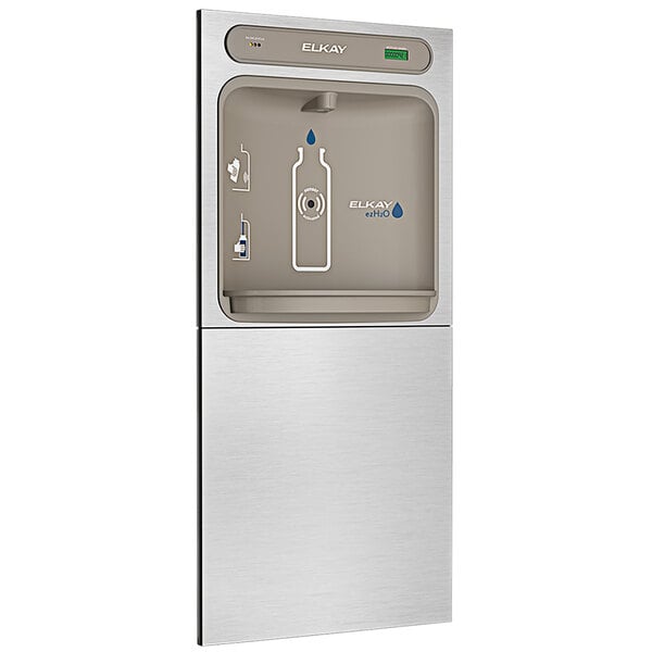 An Elkay stainless steel in-wall bottle filling station with a bottle in it.