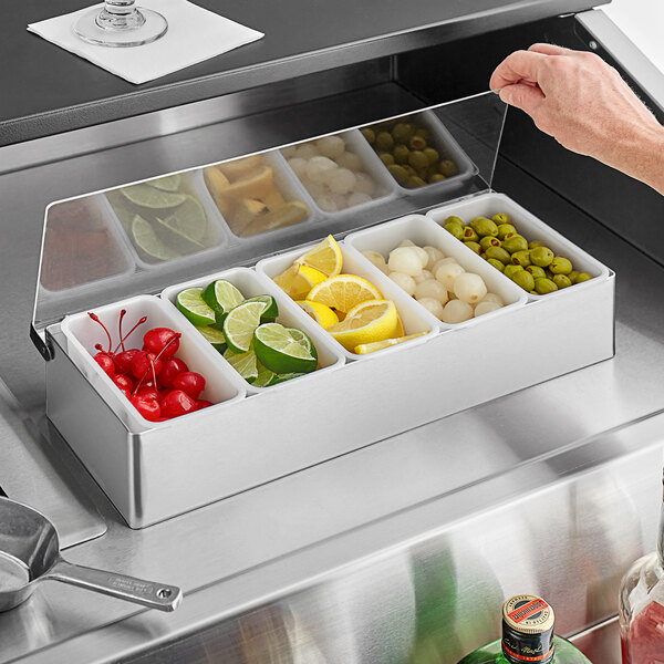 A Tablecraft stainless steel condiment bar with containers of lemons, limes, and cherries.