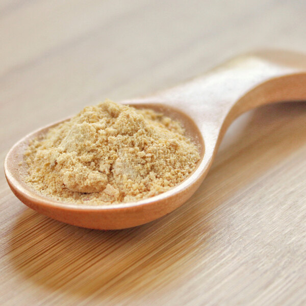 A wooden spoonful of Ripe Banana Powder.