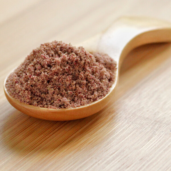 A wooden spoon filled with Murta powder.