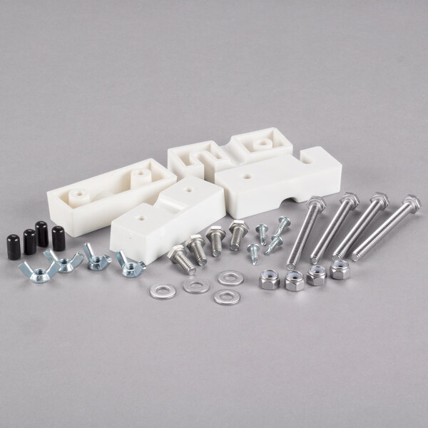 A white plastic VacPak-It bearing block with screws and nuts.