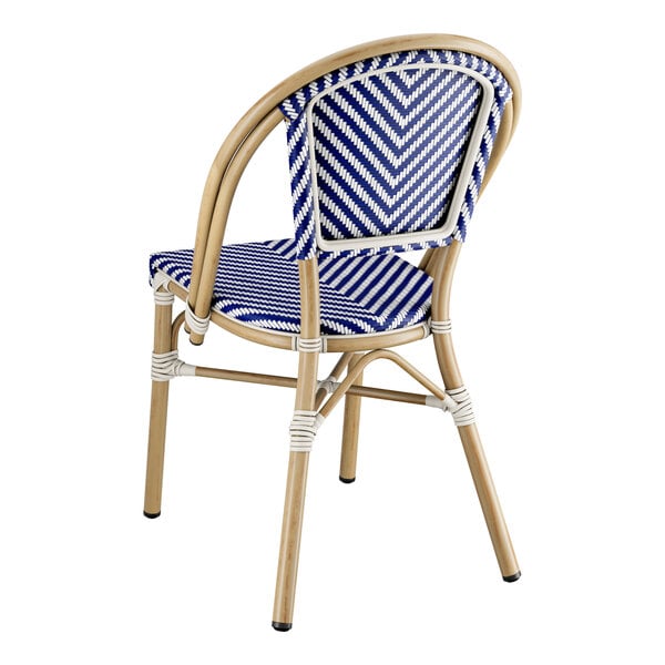A blue and white Lancaster Table & Seating outdoor side chair with a wooden frame.