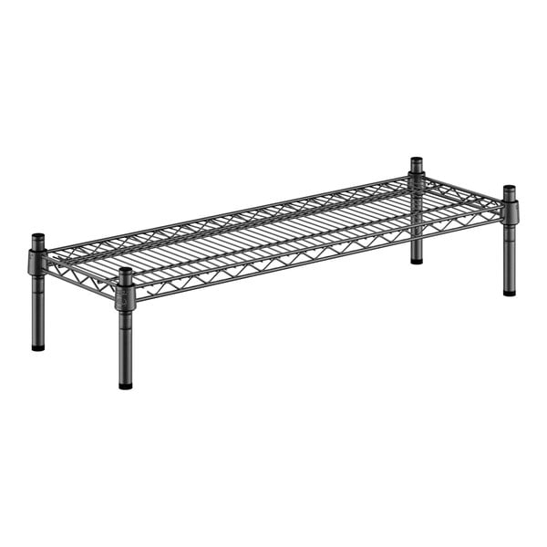 A black metal wire shelf with black legs.