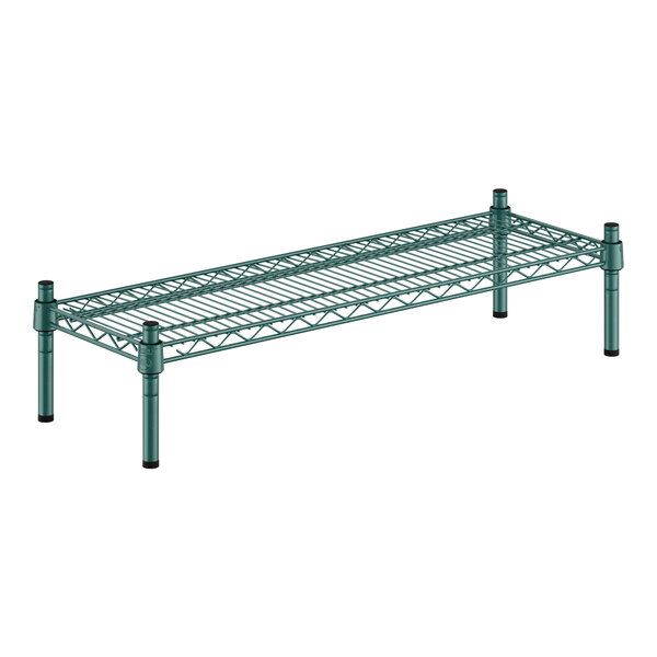 A Regency green metal shelf with black legs.