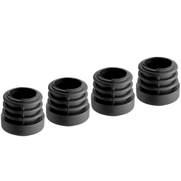 Four black plastic inserts with a hole in the middle.