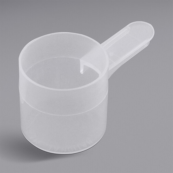 A close-up of a clear plastic scoop with a handle.