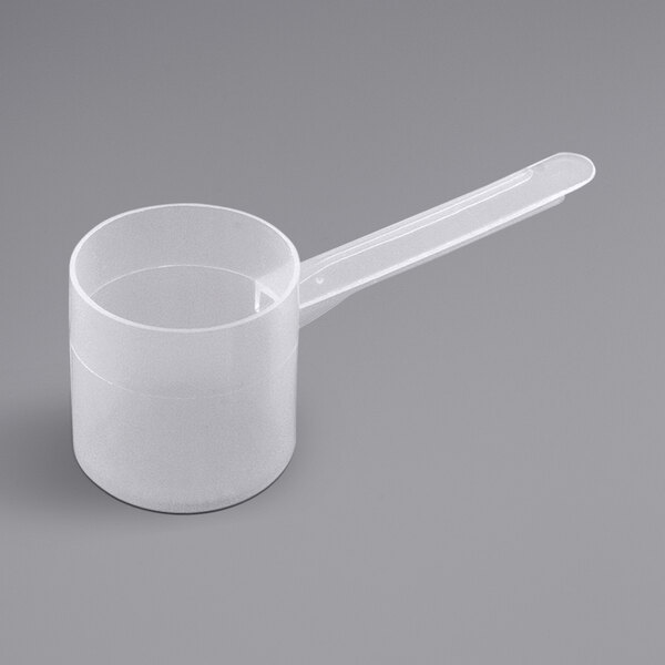 A white plastic measuring scoop with a long handle.