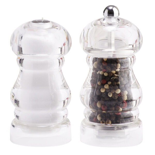 A white Chef Specialties salt shaker next to a clear Chef Specialties pepper mill.