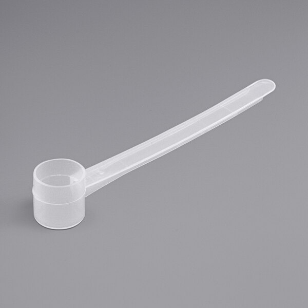 A white plastic measuring scoop with a long handle.