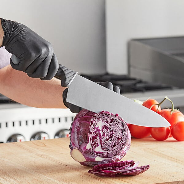 Chef knife cutting a head of radicchio