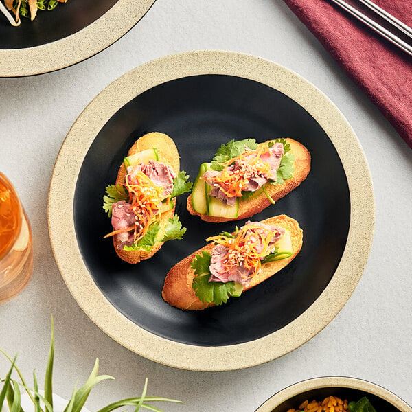 An Acopa Ugoki melamine plate with a sandwich and french fries on a table.