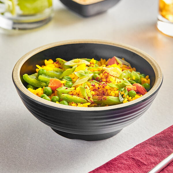 An Acopa Ugoki melamine bowl with a bowl of rice and vegetables on a table in an Asian cuisine restaurant.