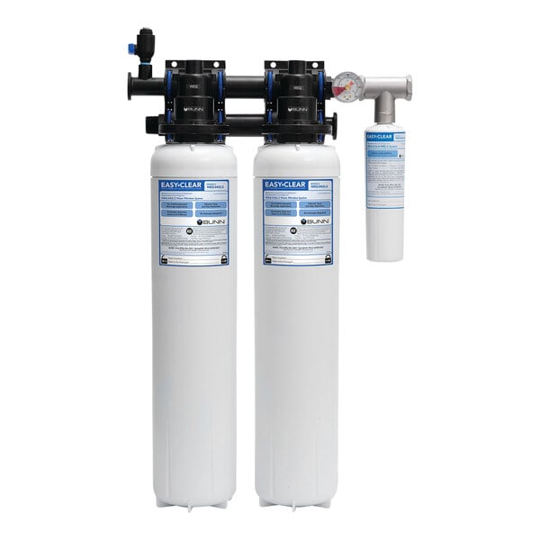 Two white water filtration cylinders with blue labels.