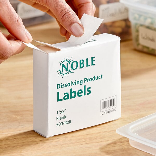 A box of Noble 1" x 2" blank dissolving product labels with a dispenser carton containing 500 labels per roll.