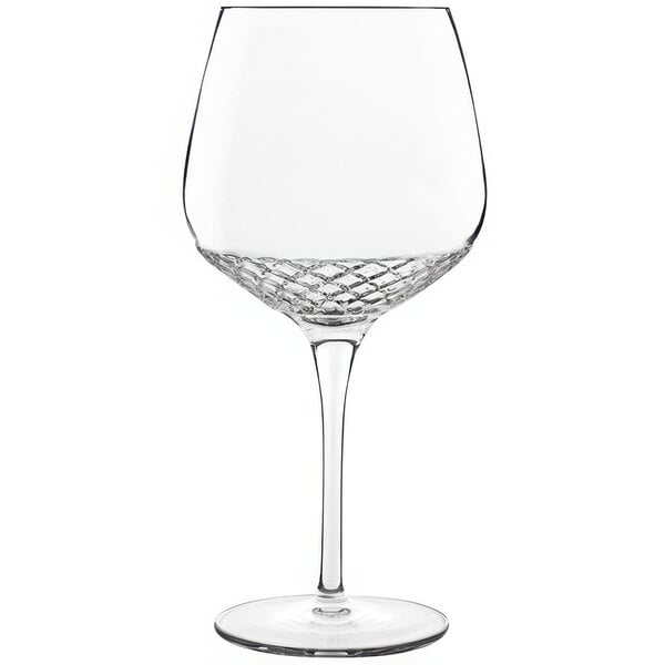 A Luigi Bormioli Roma gin and tonic glass with a clear stem and rim.