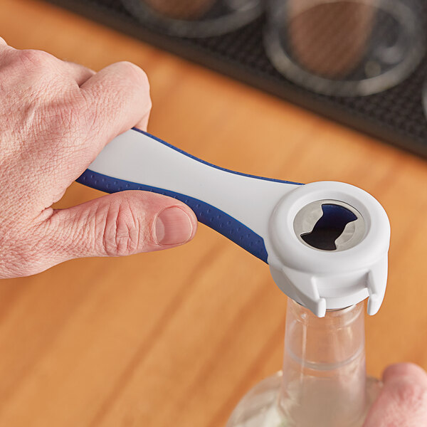 A person holding a Franmara blue and white multi-purpose opener.