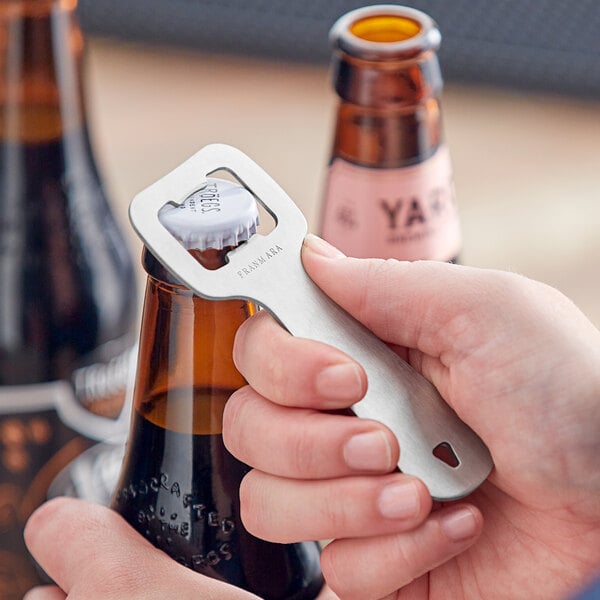 a hand holding a bottle opener